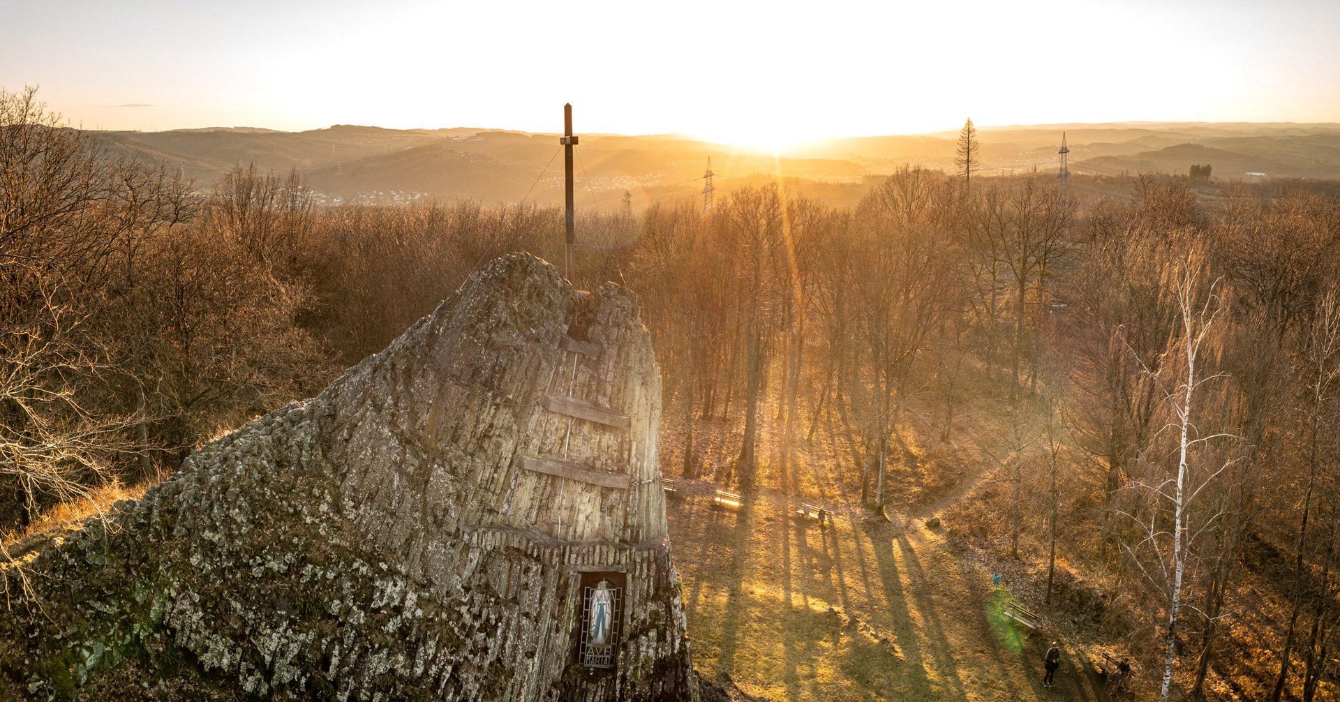 Felsformation im Wald mit Sonnenaufgang im Hintergrund